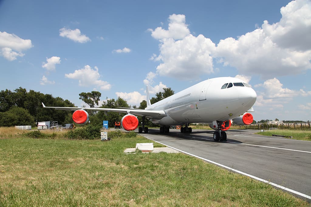 Airbus A340 widebody in long-term storage with red engine intake and exhaust covers fitted — sovereign aircraft storage and preservation